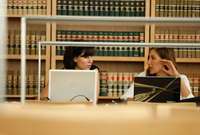 Law students study together at a table in the law library